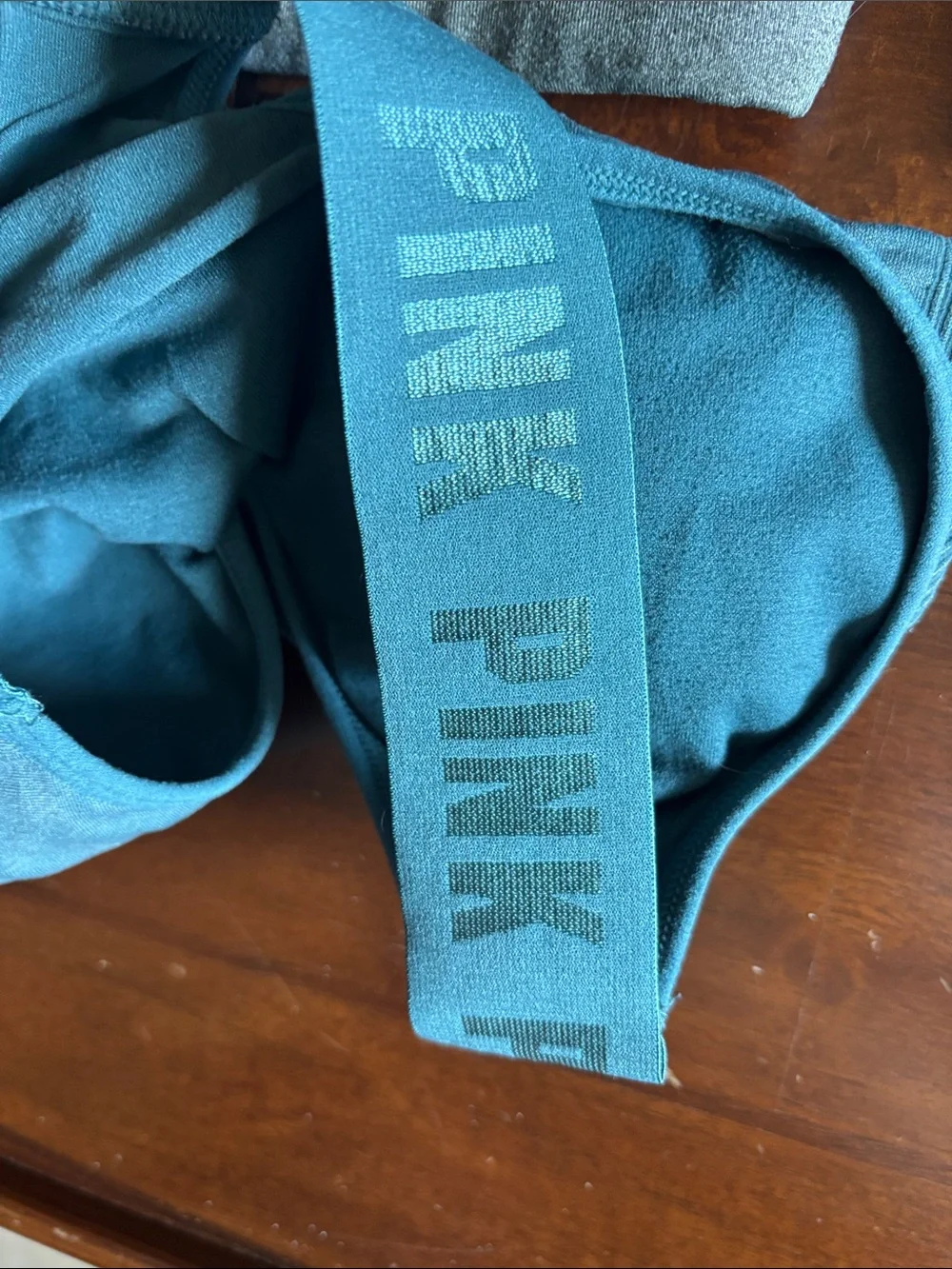 2 Nike and 1 pink Victoria’s Secret Gray Dri-FIT Racerback Sports Bra